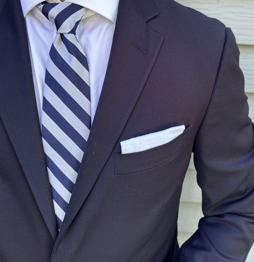 Silver striped silk necktie shown flat against a neutral background