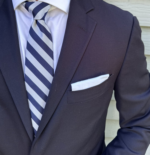 Silver striped silk necktie shown flat against a neutral background