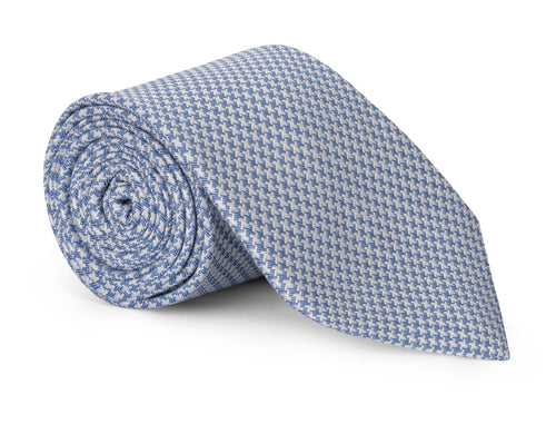 Blue houndstooth silk necktie shown close up, small-scale check weave
