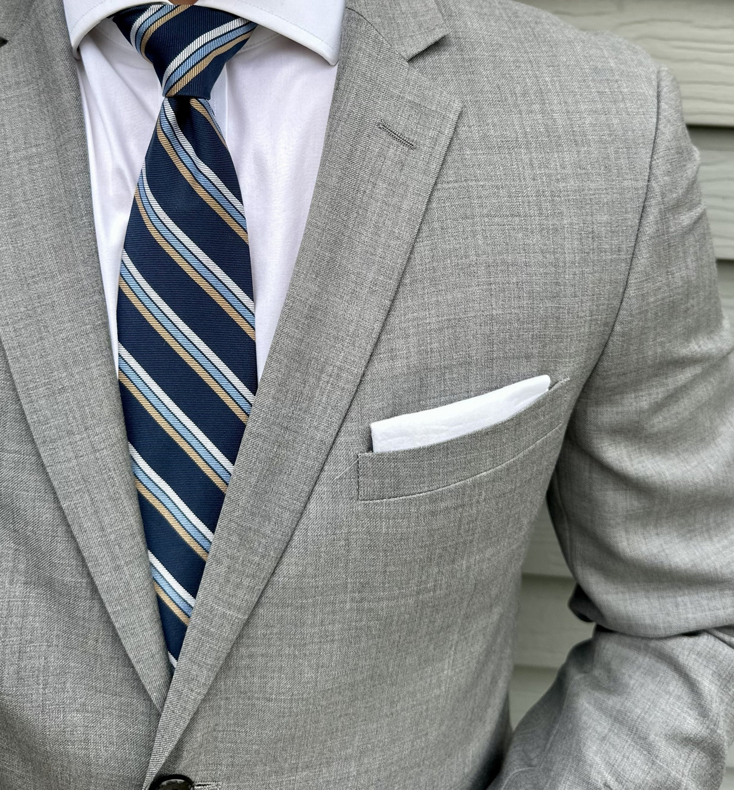 Navy mogador striped necktie with a matte textured finish, laid flat