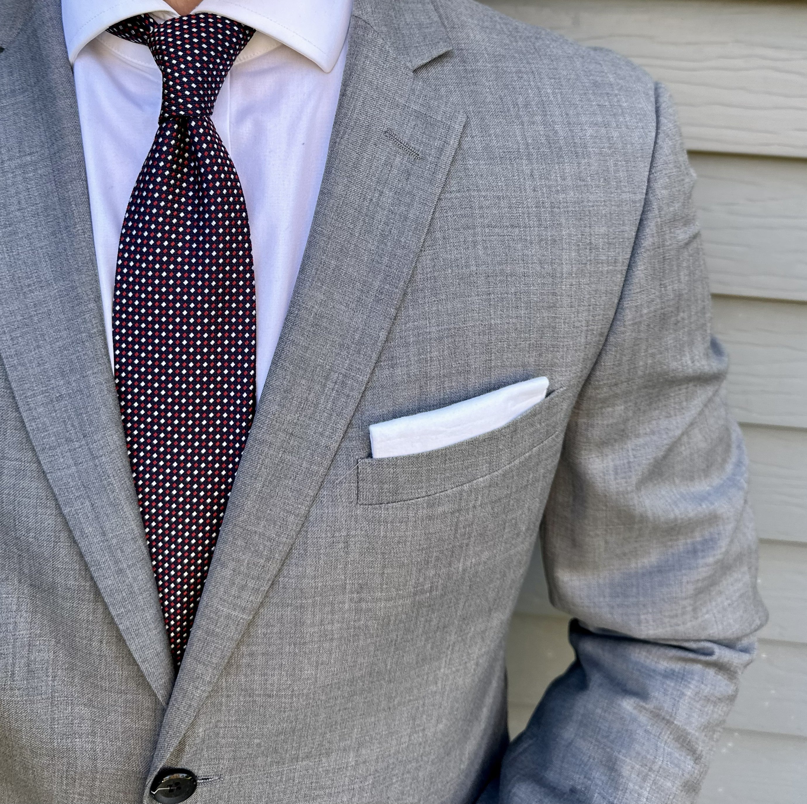 Navy semi-solid silk necktie shown knotted, subtle woven texture