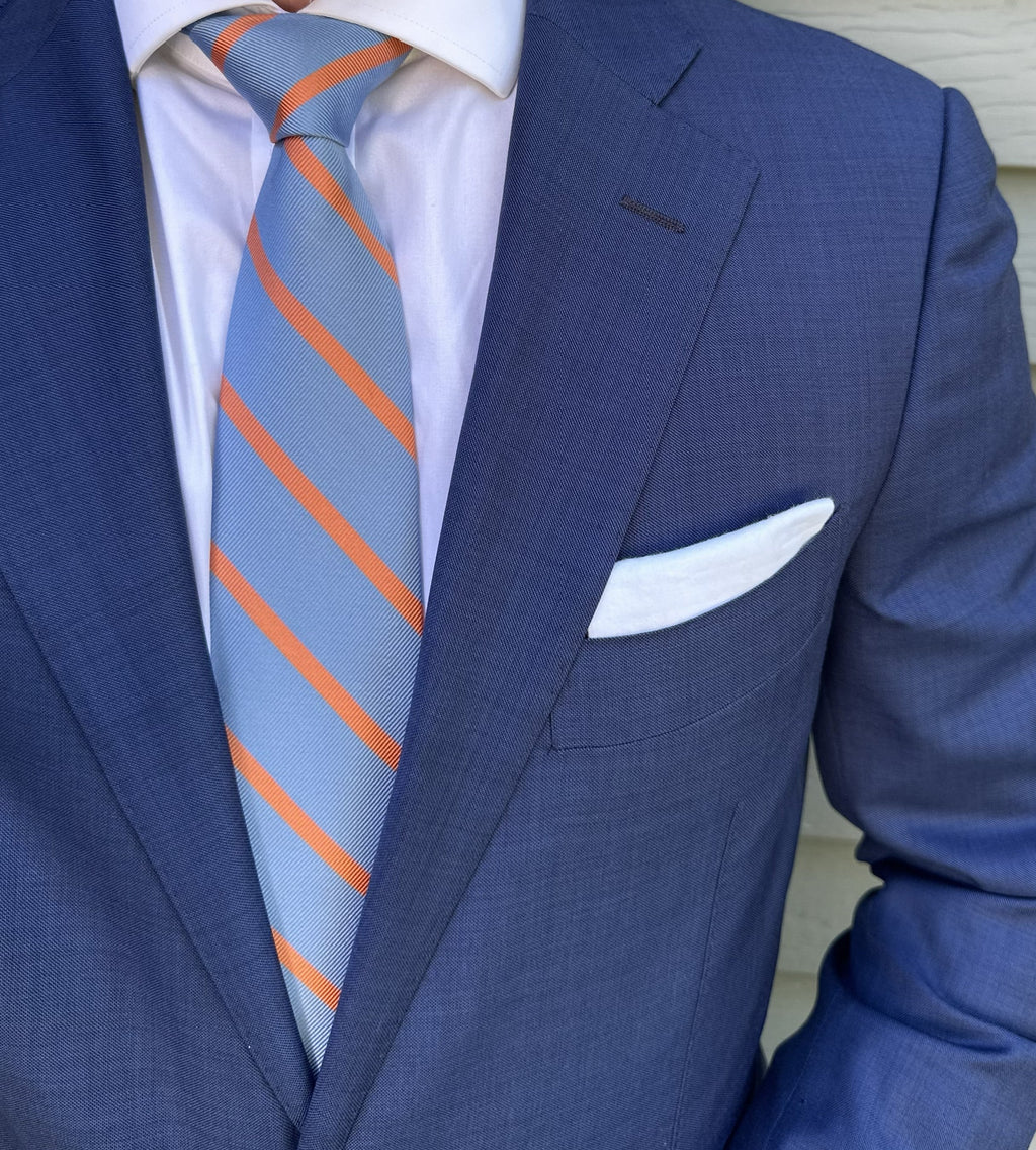 Blue striped silk necktie photographed flat with the stripe repeat clear