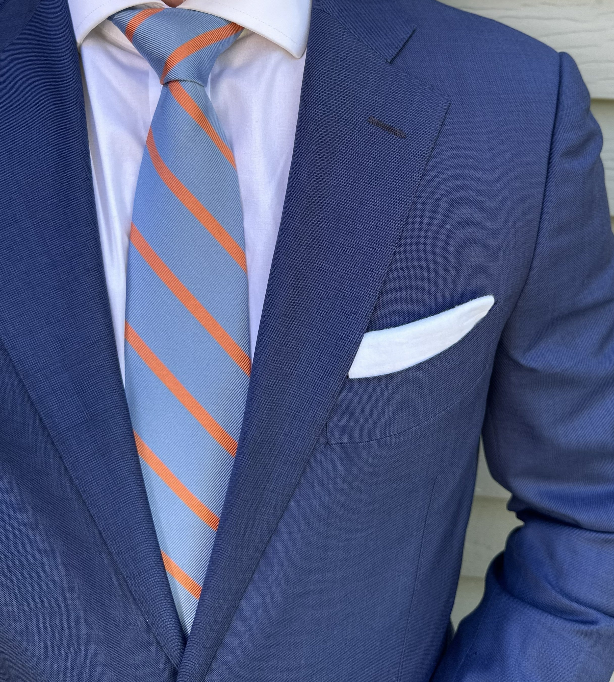 Blue striped silk necktie photographed flat with the stripe repeat clear