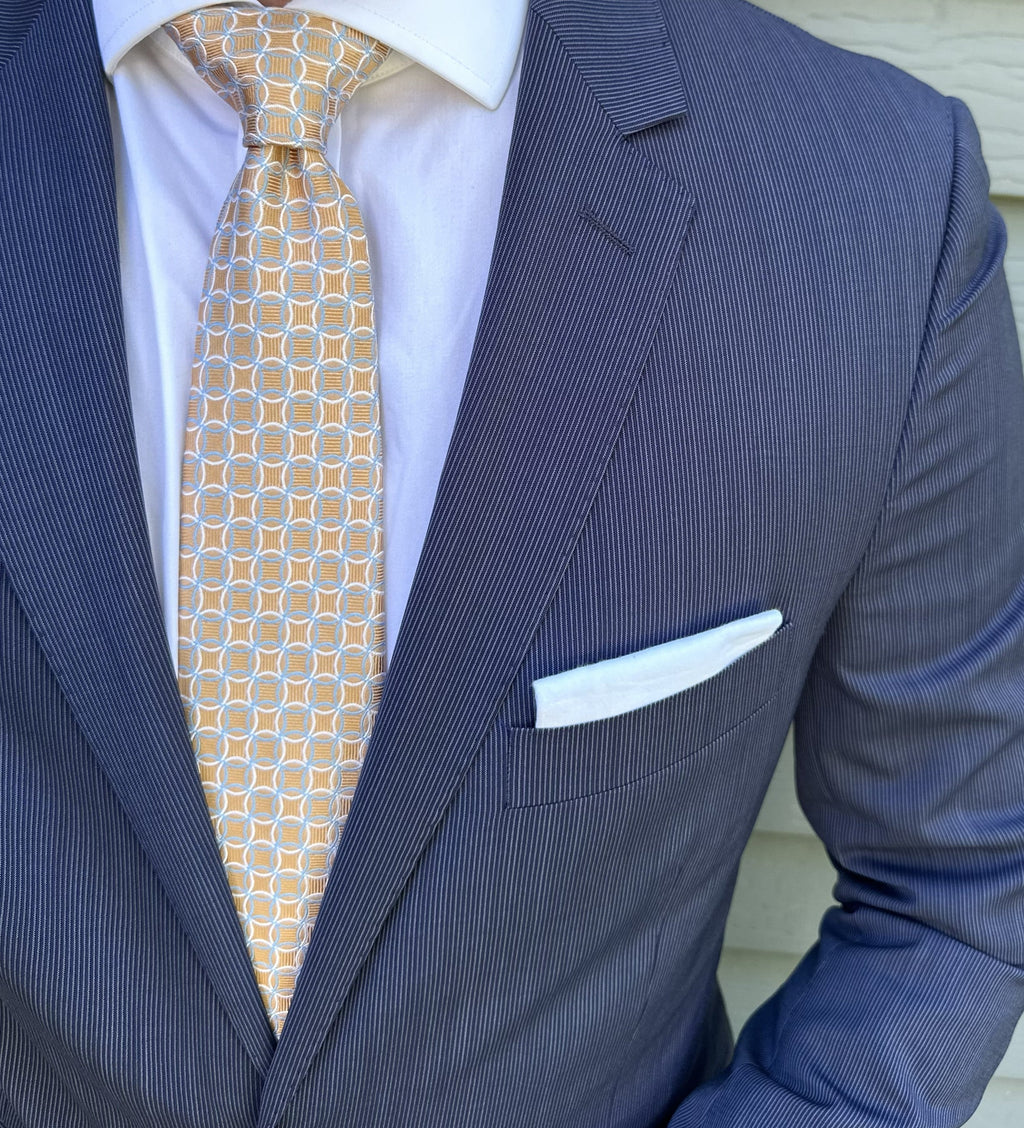 Orange and blue geometric jacquard silk necktie shown in close detail