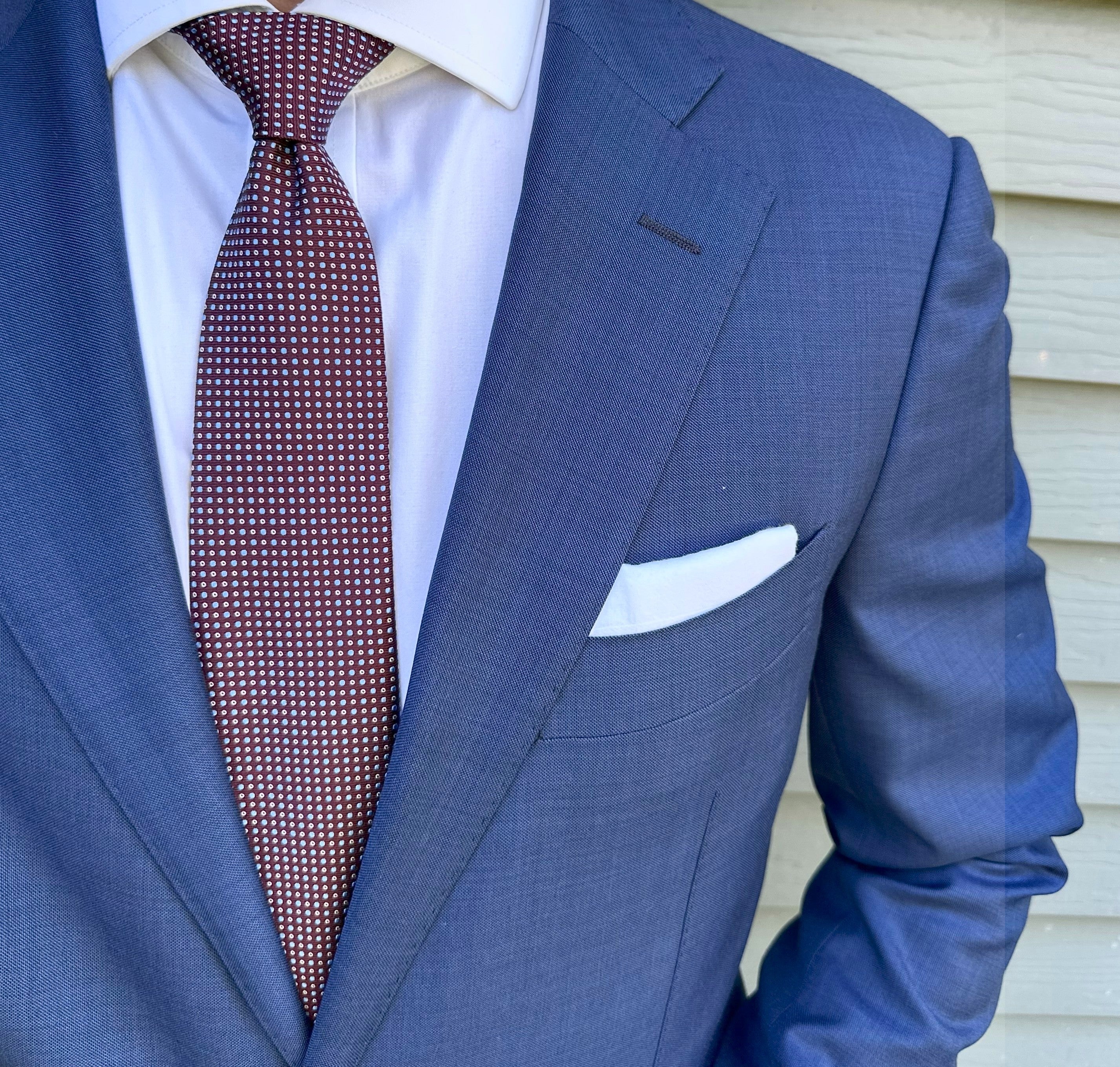 Wine red semi-solid silk necktie shown close up, subtle weave detail