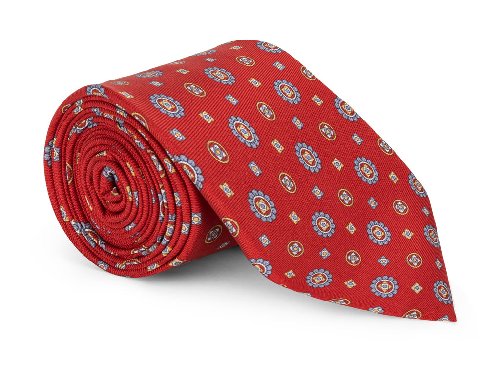 Vivid red foulard necktie printed in blue, gold and white on silk twill
