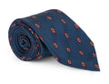 Blue silk necktie with a repeating medallion motif, laid flat