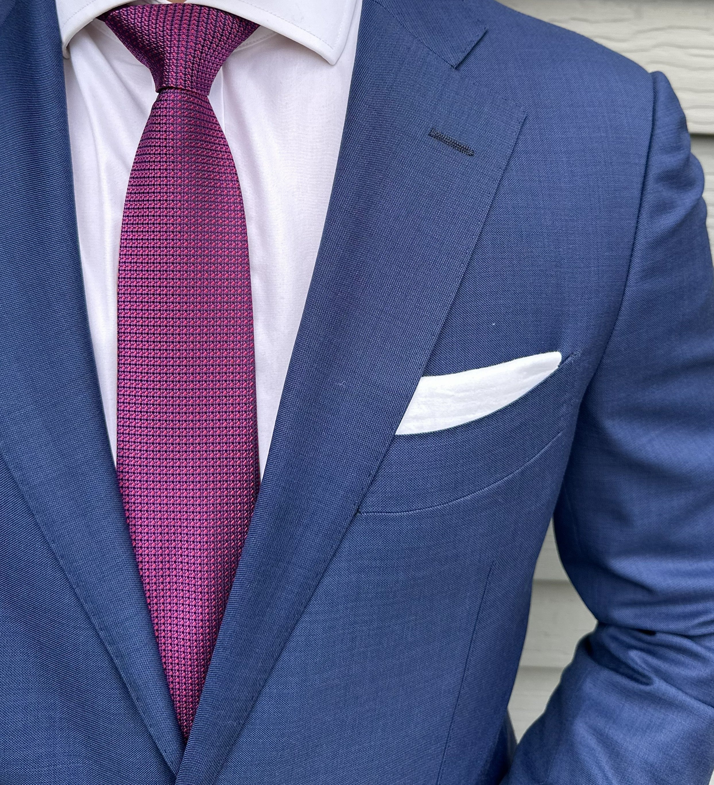 Berry red semi-solid silk necktie shown close up, subtle woven texture