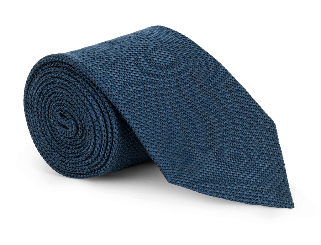 Navy grenadine silk necktie photographed flat, textured weave in detail