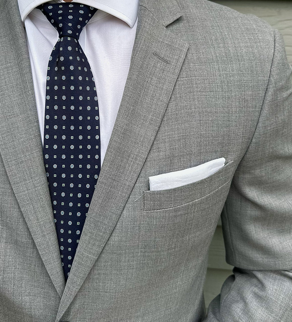 Navy silk necktie with a micro geometric motif, shown in close detail