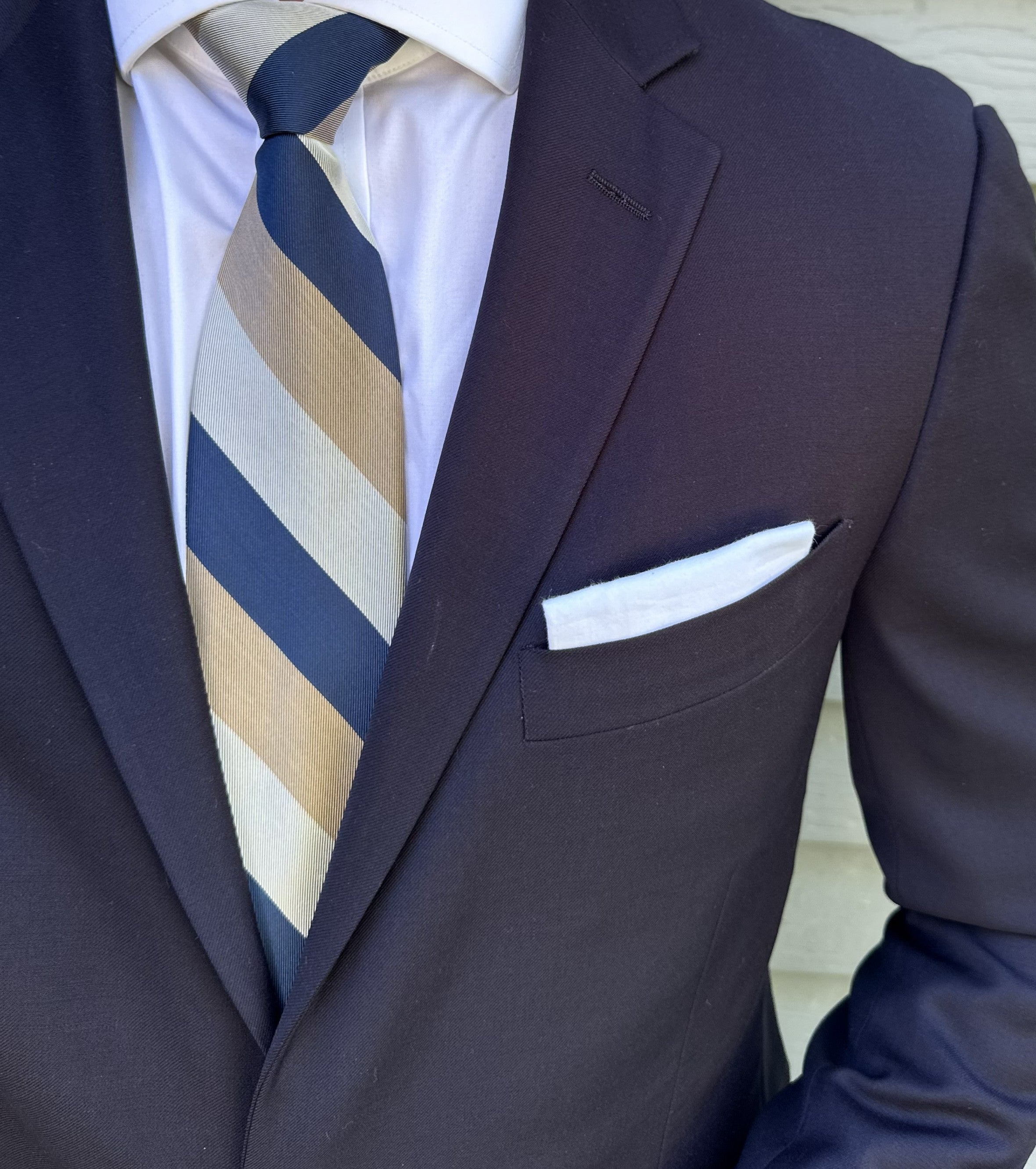 Multi-coloured striped silk necktie shown knotted, several stripe tones