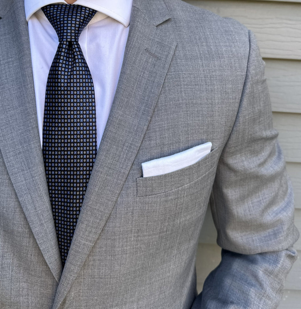 Black satin silk necktie with a foulard motif, sheen visible in light