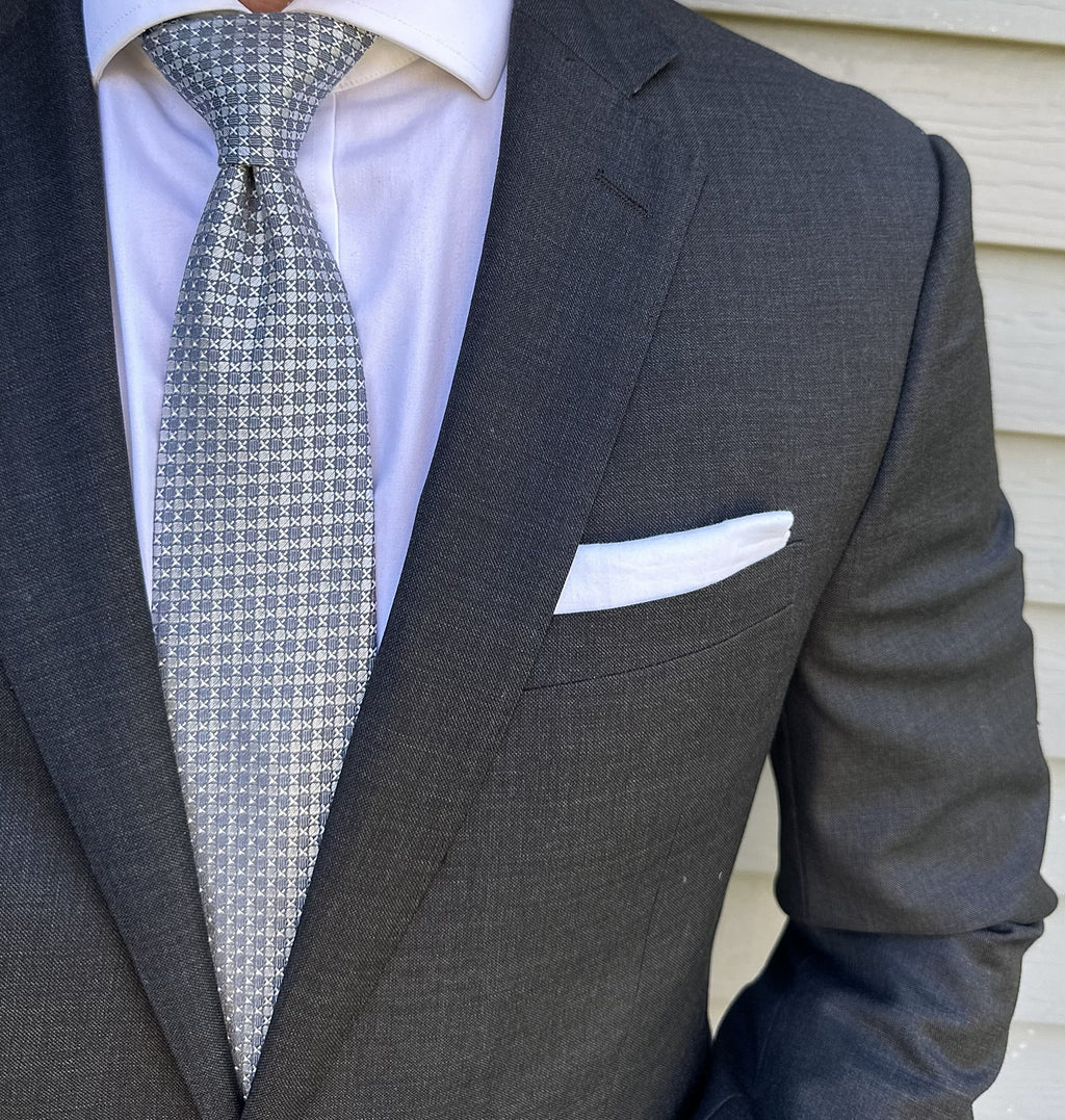 Silver semi-solid silk necktie shown flat, fine woven texture visible