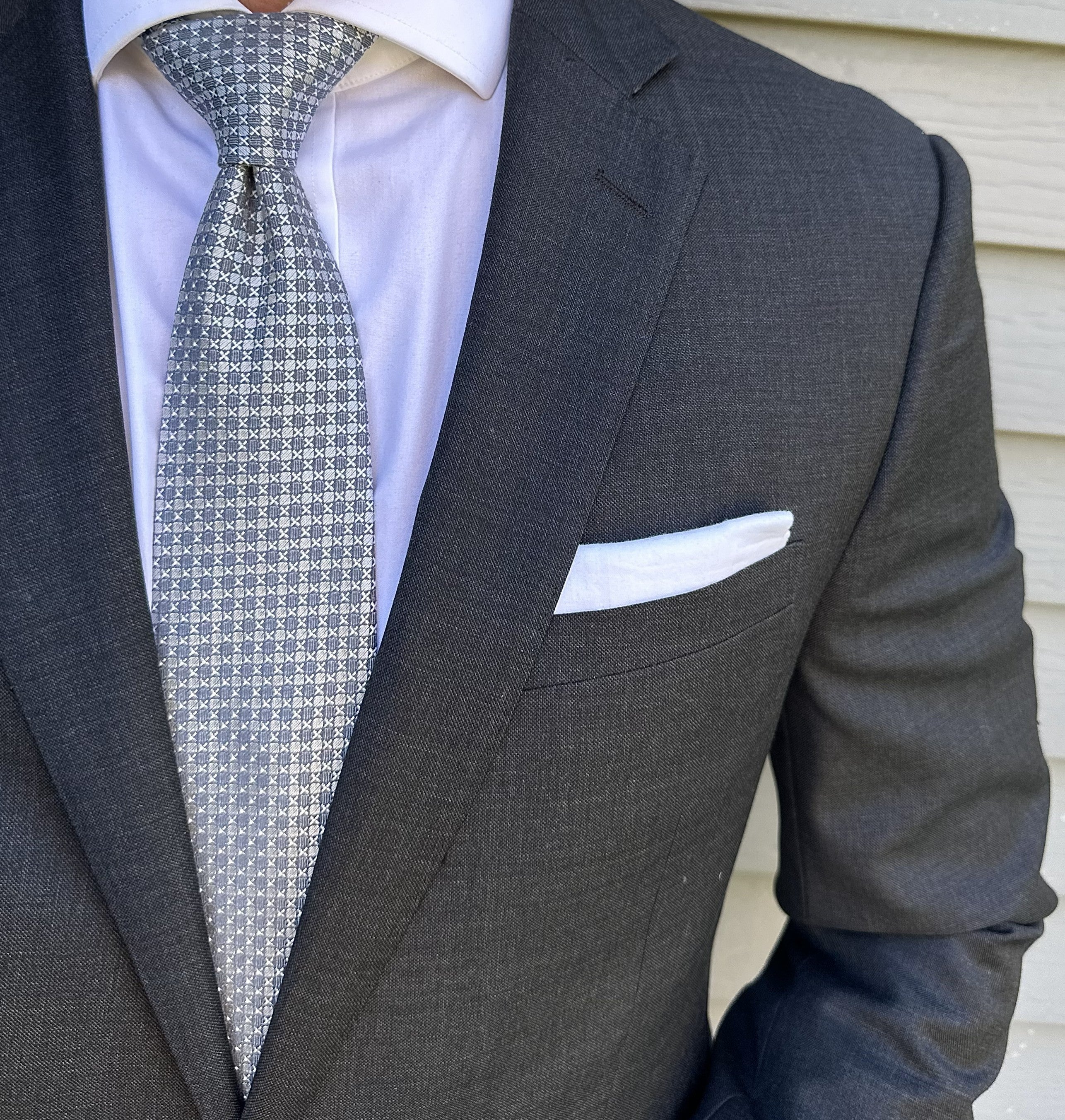 Silver semi-solid silk necktie shown flat, fine woven texture visible